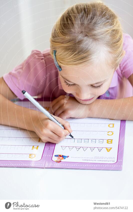 Little girl writing alphabet write Alphabets females girls child children kid kids people persons human being humans human beings casual leisure wear