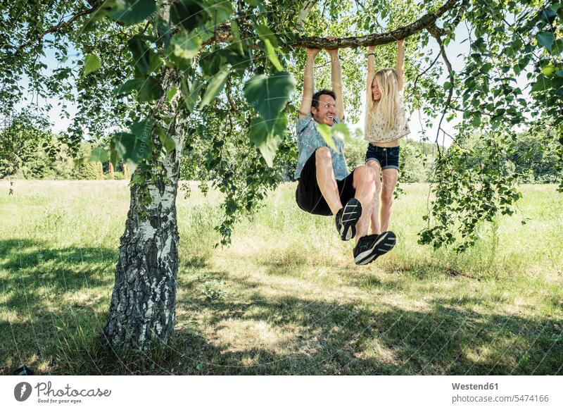 Father and daughter hanging on a branch of a birch tree human human being human beings humans person persons caucasian appearance caucasian ethnicity european