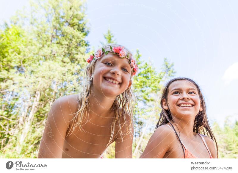 Portrait of happy girl wearing flower crown and friend outdoors in summer female friends hair wreath Flower Crown Floral Crown happiness summer time summery