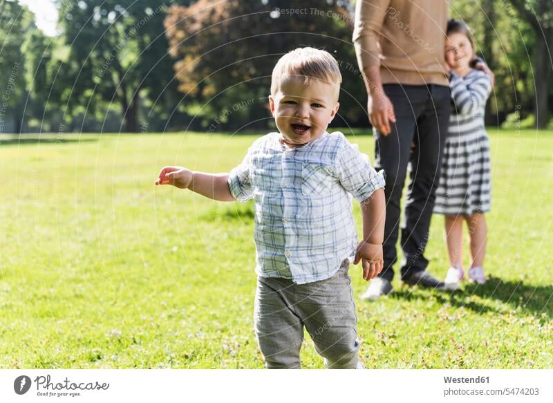 Happy boy with family in a park parks happiness happy baby boys male families babies infants people persons human being humans human beings daughter daughters