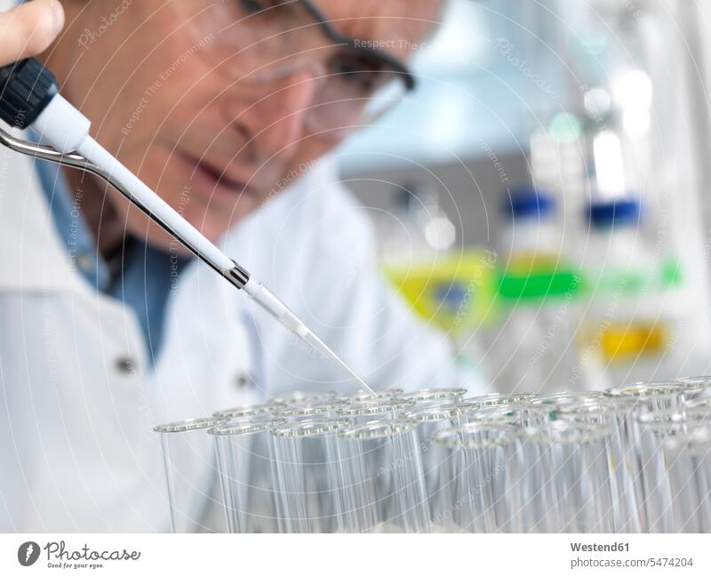 Scientist pipetting into test tubes during an experiment in the laboratory test-tube Testtube Testtubes scientist experimenting pipette laboratory equipment
