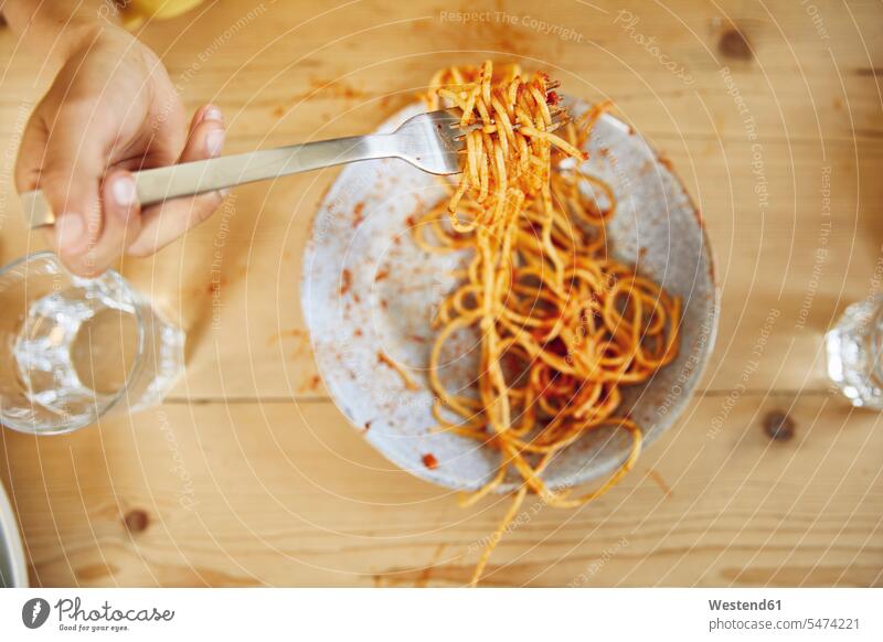 Hand of boy holding fork with spaghetti at home indoor indoor shot indoor shots interior interior view Interiors Alimentation food Food and Drinks Nutrition