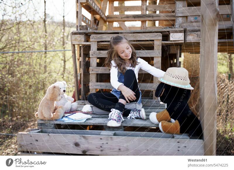 Girl playing with her teddy bears at tree house teddies teddy-bear smile Seated sit delight enjoyment Pleasant pleasure happy Contented Emotion pleased free