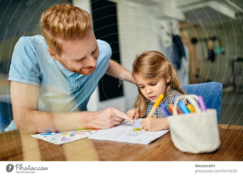 Father and daughter sitting at table, painting colouring book human human being human beings humans person persons caucasian appearance caucasian ethnicity