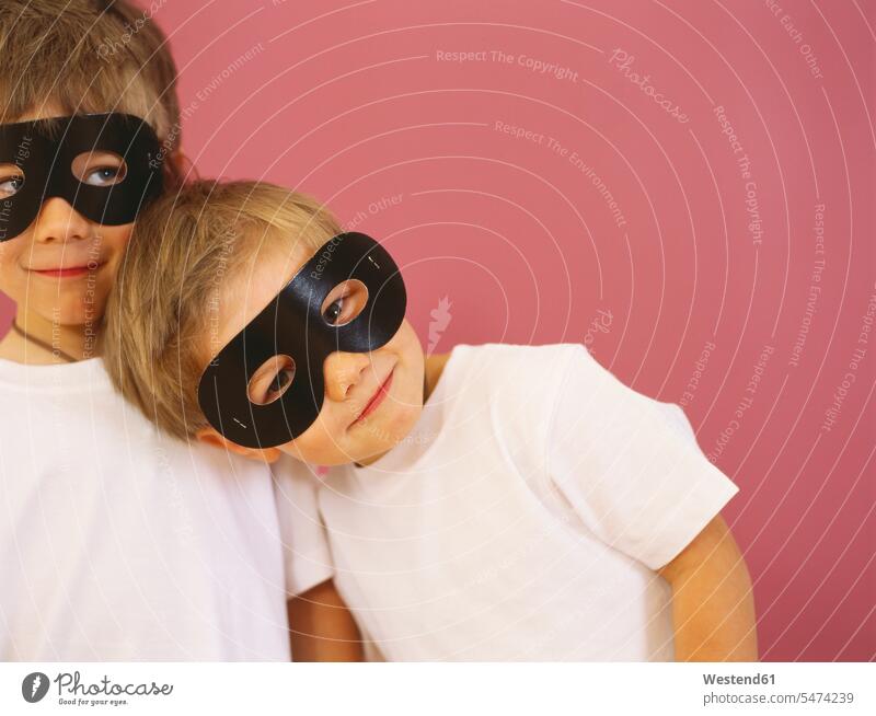 Portrait of two smiling little boys wearing black eye masks smile males portrait portraits child children kid kids people persons human being humans