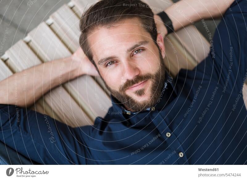 Portrait of bearded young man lying down laying down lie full beard confidence confident portrait portraits men males people persons human being humans