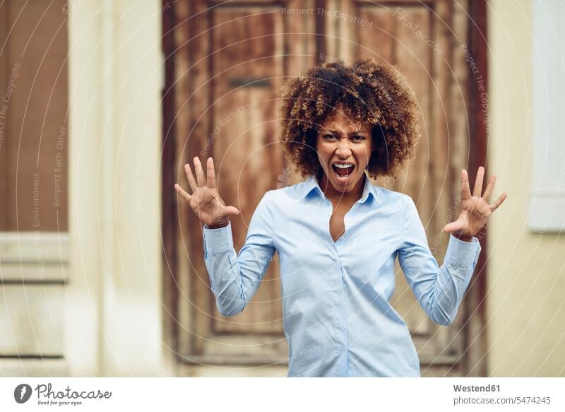 Portrait of woman with afro hairstyle screaming outdoors portrait portraits shouting females women Afro Afros Adults grown-ups grownups adult people persons
