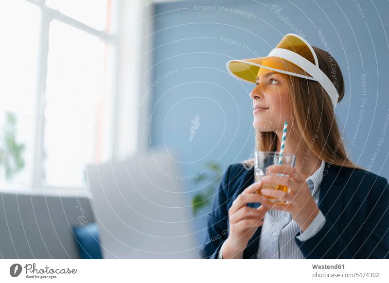 Portrait of a young businesswoman, sitting in office, dreaming of a holiday vacation Holidays portrait portraits daydreaming day dreaming Daydreams Day Dream