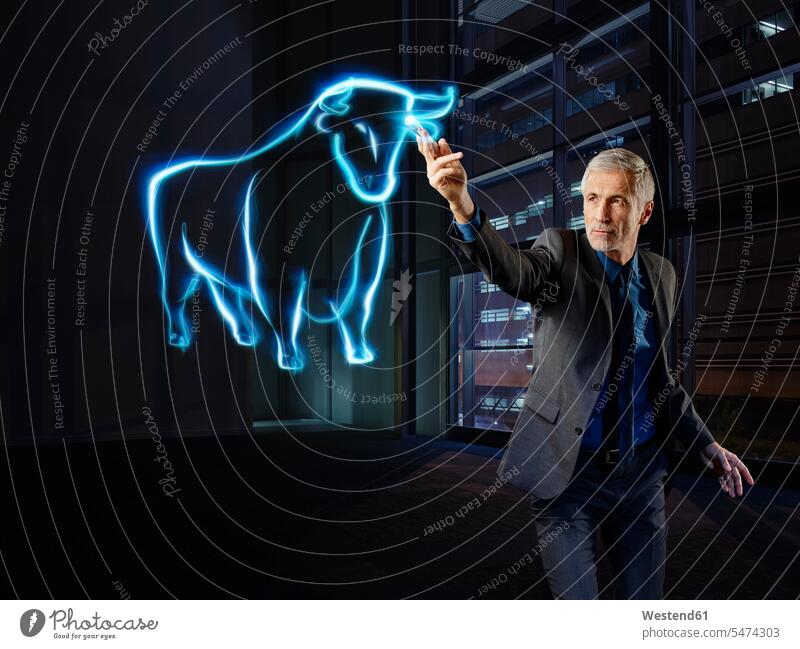 Businessman painting a bull with light Business man Businessmen Business men stock market stocks and shares financial market stock exchange trading lights