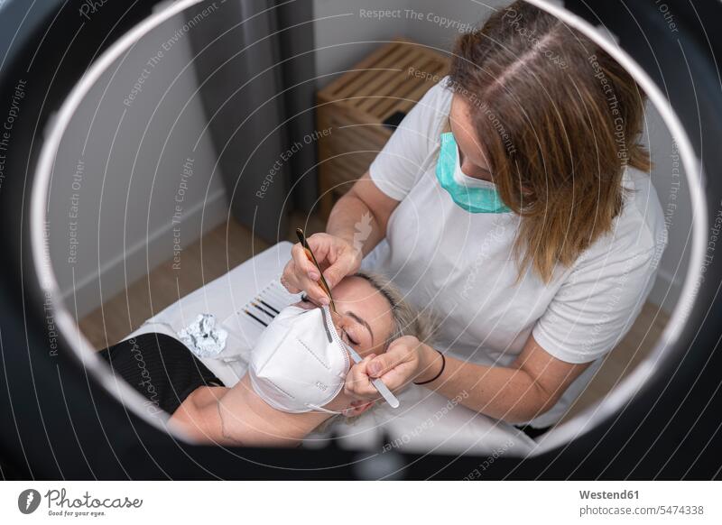 Female beautician giving beauty treatment to customer at spa color image colour image Spain indoors indoor shot indoor shots interior interior view Interiors