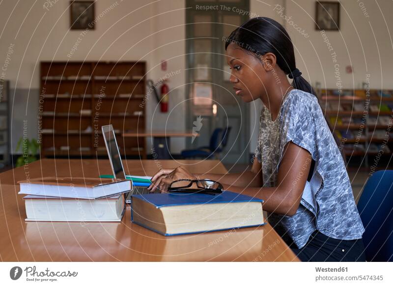 Young student working on laptop at National library, Maputo, Mocambique human human being human beings humans person persons African black black ethnicity