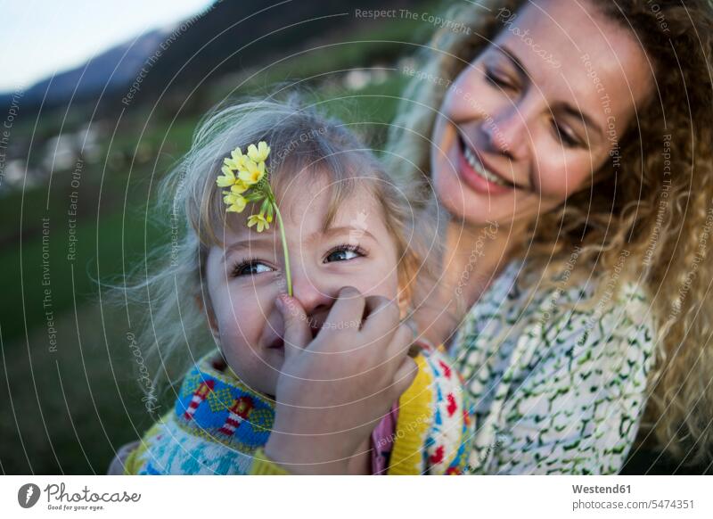 Happy mother and daughter with flowers on a meadow meadows happiness happy Flower Flowers family families mommy mothers ma mummy mama daughters people persons