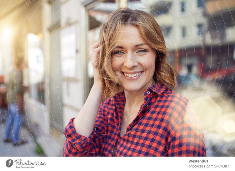 Portrait of smiling woman in the city portrait portraits females women smile town cities towns Adults grown-ups grownups adult people persons human being humans