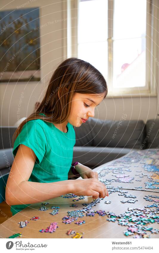 Girl doing a jigsaw at home human human being human beings humans person persons caucasian appearance caucasian ethnicity european 1 one person only