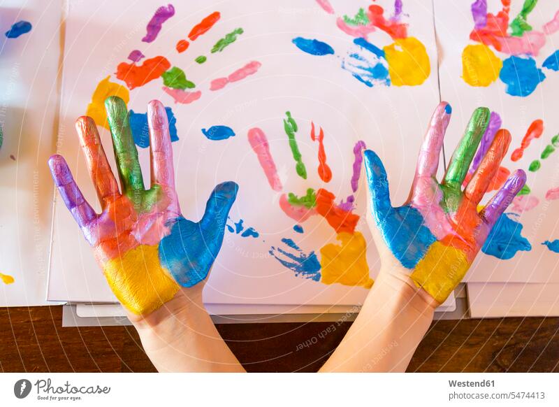 Girl playing with finger paint girl females girls painting hand human hand hands human hands fingerpainting finger paints colour color colors Paints colours