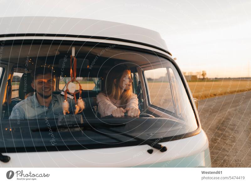 Couple driving camper van on dirt track in rural landscape couple twosomes partnership couples Camper field path field paths landscapes scenery terrain country