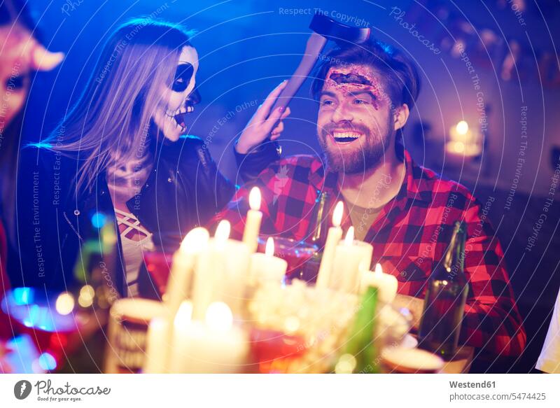 Couple at a Halloween party couple twosomes partnership couples All Hallows' Eve hooded friends celebrating celebrate partying laughing Laughter Party Parties