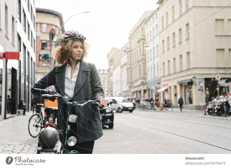 Woman with bicycle in the city, Berlin, Germany business life business world business person businesspeople business woman business women businesswomen