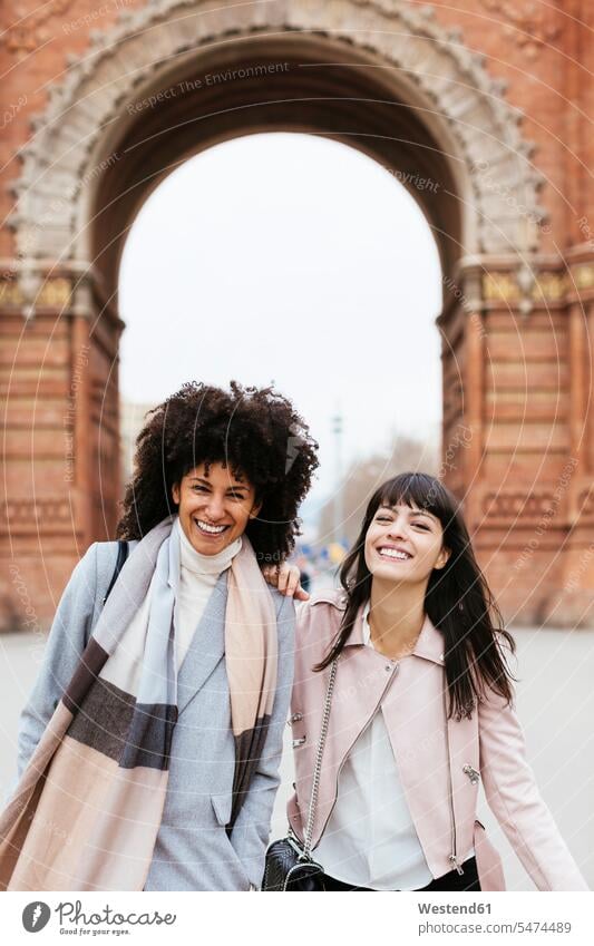 Spain, Barcelona, portrait of two happy women at a gate happiness portraits gates woman females female friends Adults grown-ups grownups adult people persons