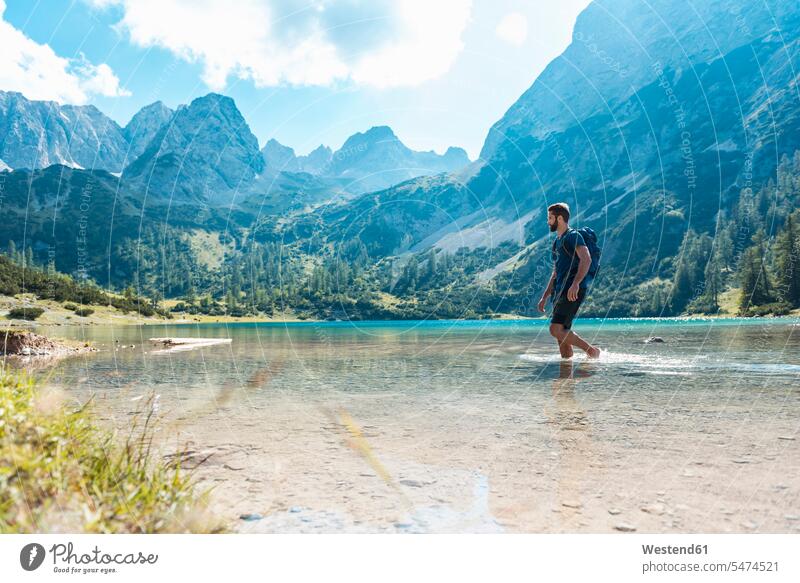 Austria, Tyrol, Hiker at Lake Seebensee walking ankle deep in water going lake lakes hiking hike Ankle-Deep In Water Ankles Deep In Water hiker wanderers hikers