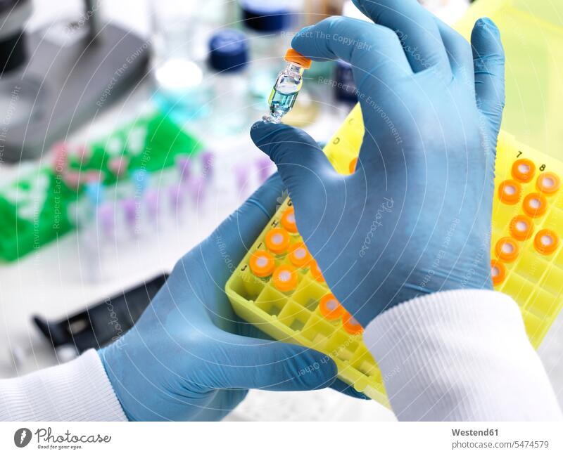 Research experiment, scientist preparing sample into vials for analysis experimenting ampulla phial ampullae phials researcher research scientist hand
