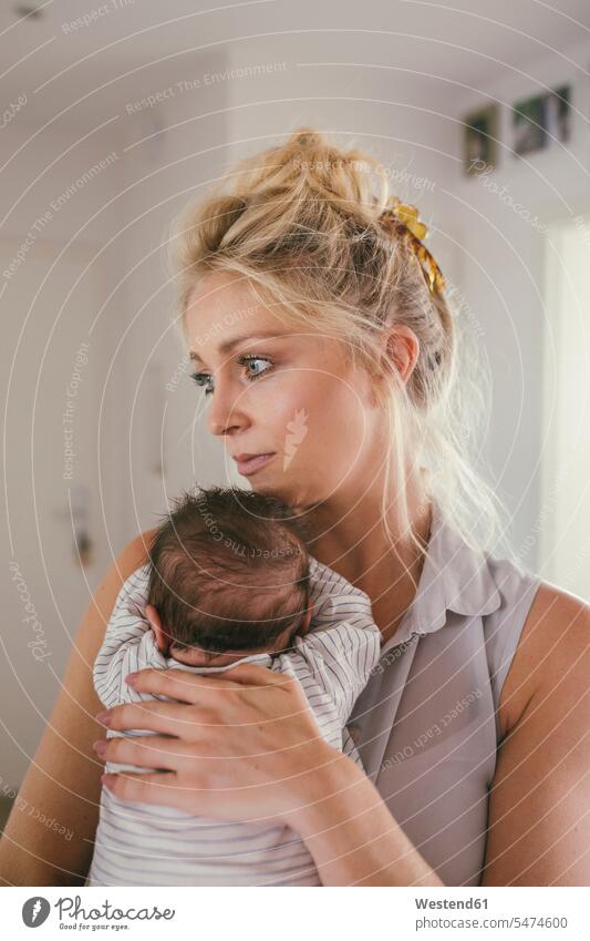 Mother holding her baby at home infants nurselings babies mother mommy mothers ma mummy mama people persons human being humans human beings parents family