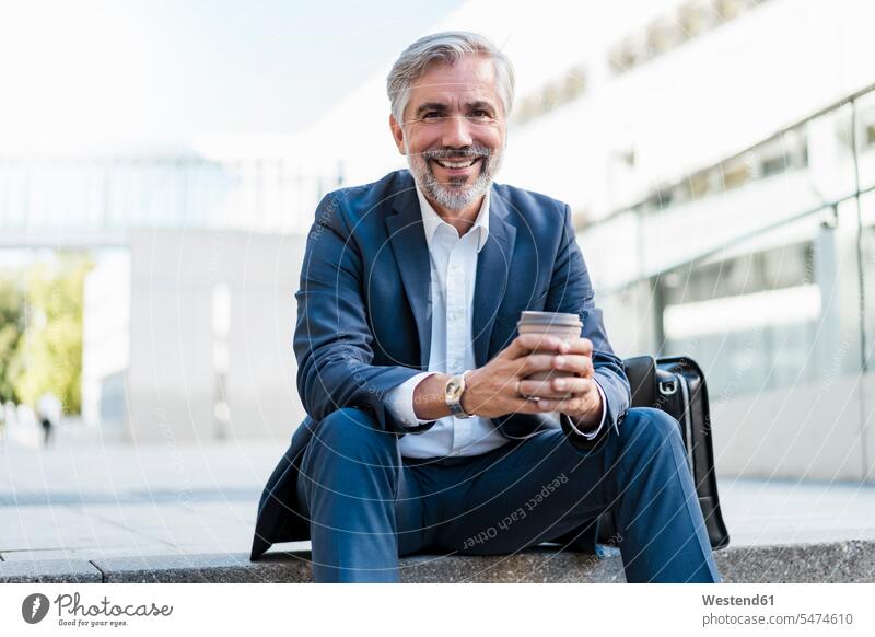Portrait of smiling mature businessman sitting on stairs in the city holding takeaway coffee human human being human beings humans person persons