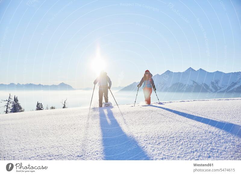 Austria, Tyrol, snowshoe hikers at sunrise sun rise sunrises winter hibernal snowshoeing atmosphere atmospheric mood moody Atmospheric Mood Vibe Idyllic