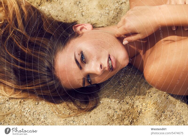 Portrait of lascivious young woman lying on the beach portrait portraits females women Suggestive risque laying down lie lying down beaches Adults grown-ups