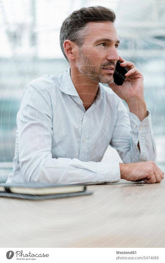Portrait of businessman in a cafe talking on the phone human human being human beings humans person persons caucasian appearance caucasian ethnicity european 1