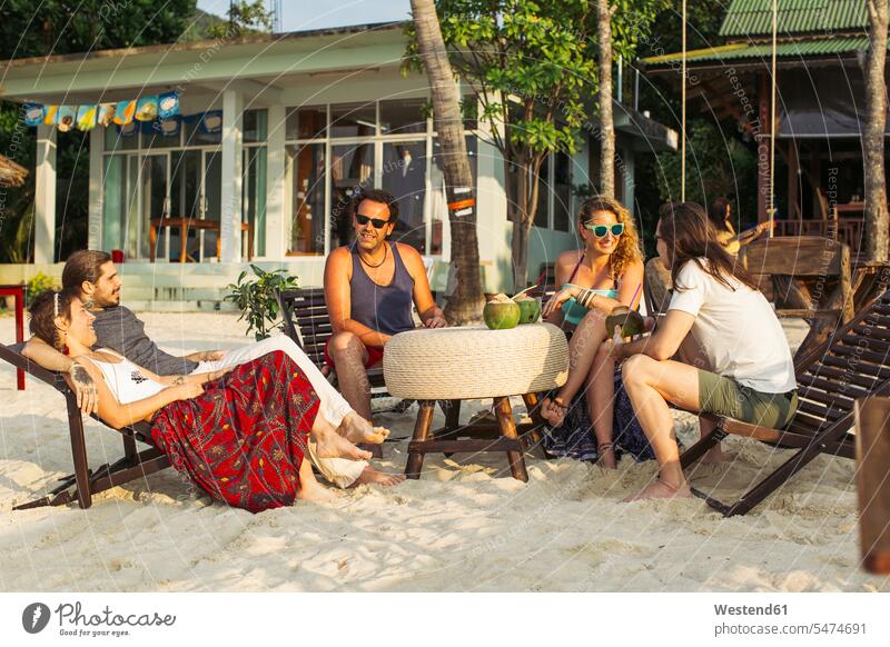 Thailand, Koh Phangan, friends having fun in a cafe at the beach Fun funny beaches mate friendship deckchair deck chair deckchairs deck chairs relationship