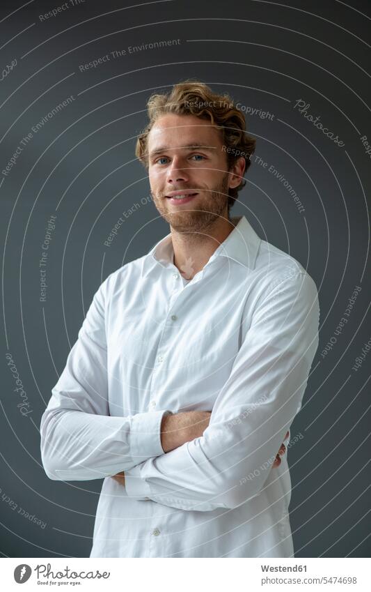 Portrait of young smiling businessman, wearing white shirt, looking at camera human human being human beings humans person persons caucasian appearance
