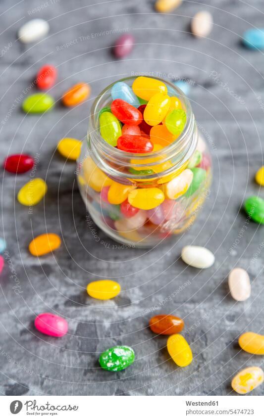 Glass of colourful sweet jellybeans on gray background jelly bean jelly beans colorful gray backgrounds grey elevated view High Angle View High Angle Shot