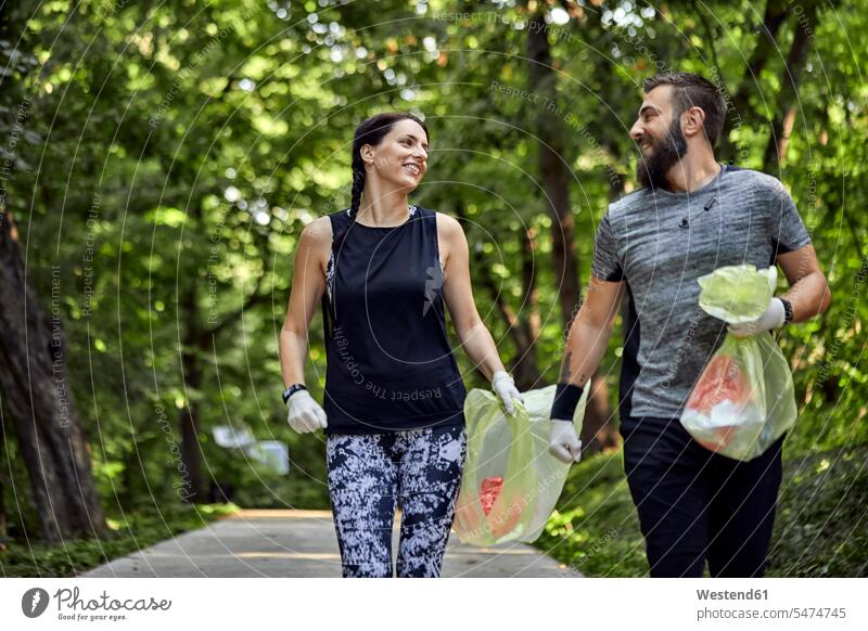Couple plogging on forest path human human being human beings humans person persons caucasian appearance caucasian ethnicity european 2 2 people 2 persons two