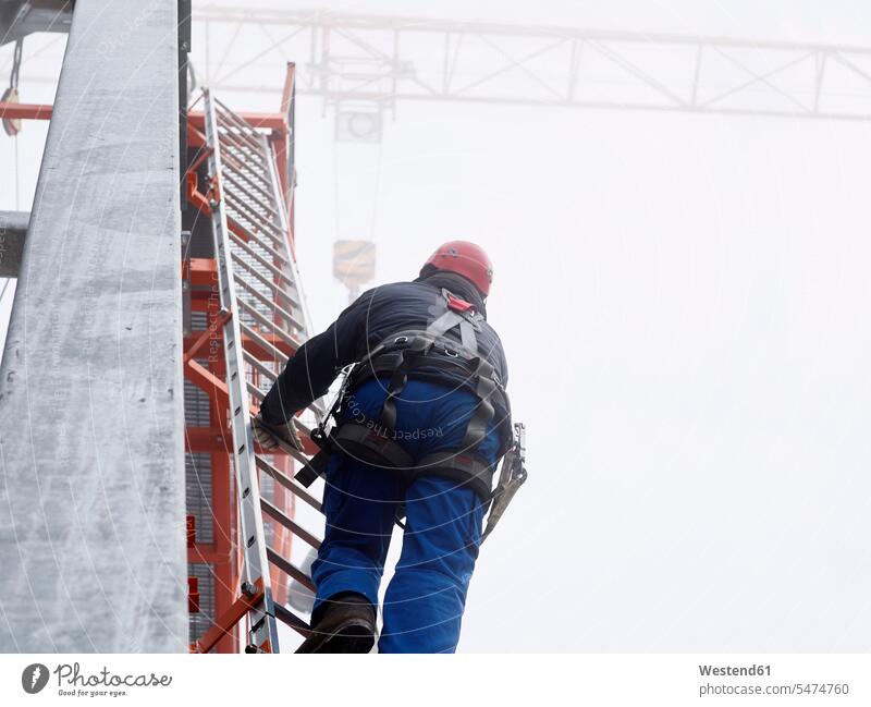 Germany, Bavaria, Garmisch-Partenkirchen, Zugspitze, installer climbing ladder on pole at goods cable lift installers Pole Poles working At Work ladders