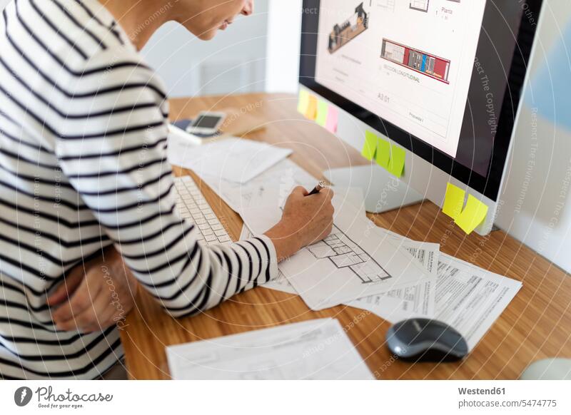 Close-up of female architect working on project in home office human human being human beings humans person persons celibate celibates singles solitary people