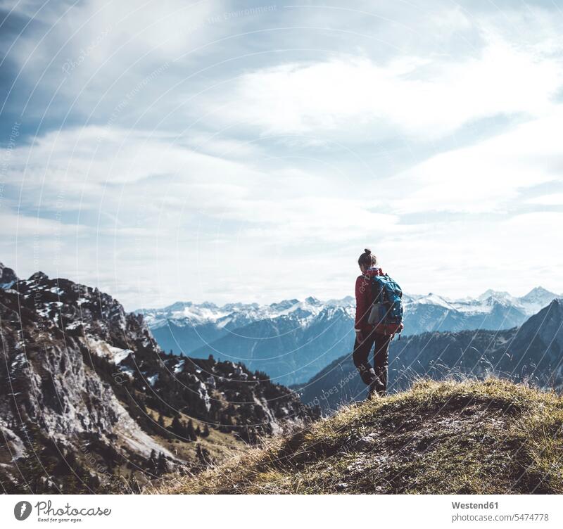 Austria, Tyrol, young woman hiking in the mountains females women hike mountain range mountain ranges Adults grown-ups grownups adult people persons human being