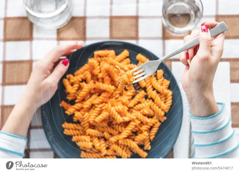Woman eating pasta at dining table at home human human being human beings humans person persons caucasian appearance caucasian ethnicity european 1