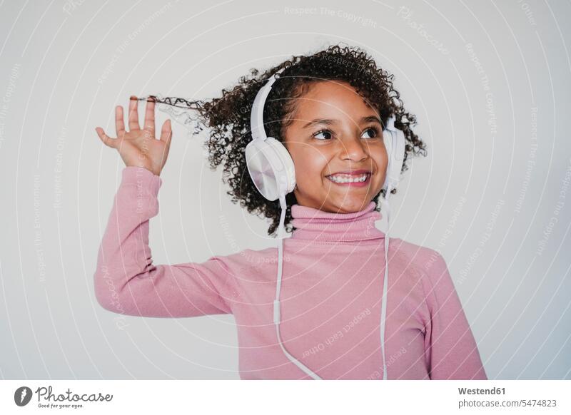 Portrait of smiling little girl listening music with headphones human human being human beings humans person persons 1 one person only only one person children