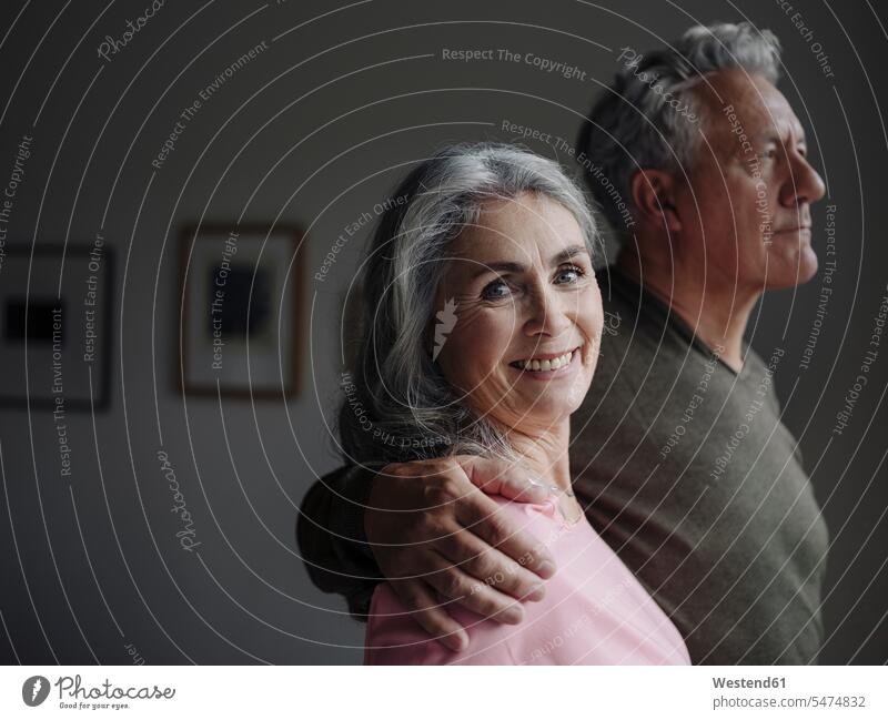 Portrait of a senior couple at home relax relaxing smile embrace Embracement hug hugging relaxation delight enjoyment Pleasant pleasure indulgence indulging