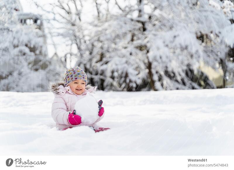 Cute little girl playing with snow in winter hibernal cute twee Cutie females girls weather child children kid kids people persons human being humans