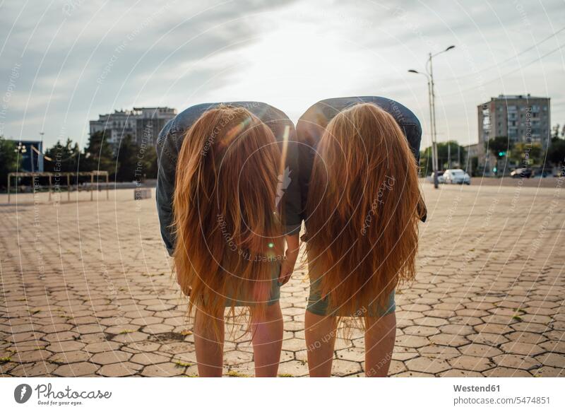 Redheaded twins in the city, headbangen long hair longhair long-haired Headbangen redheaded red hair red hairs red-haired equality sister sisters woman females