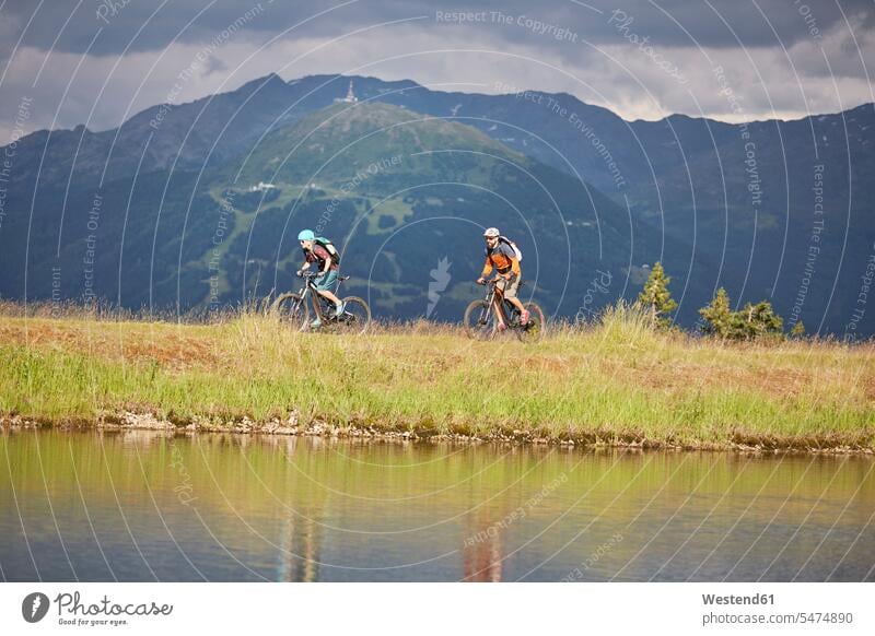 Austria, Tyrol, male and female mountainbiker couple twosomes partnership couples riding bicycle riding bike bike riding cycling bicycling pedaling