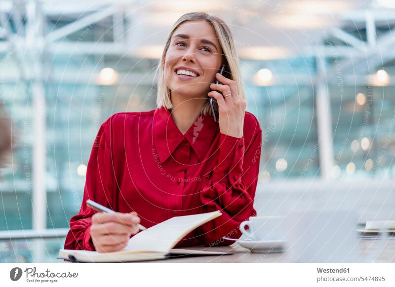 Smiling young businesswoman with notebook on the phone Occupation Work job jobs profession professional occupation business life business world business person