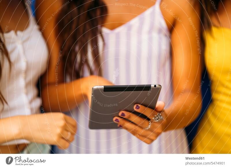 Close-up of three young women sharing a tablet human human being human beings humans person persons caucasian appearance caucasian ethnicity european Group