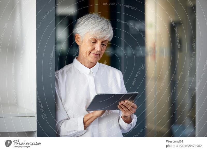 Portrait of senior businesswoman using digital tablet in office business life business world business person businesspeople business woman business women