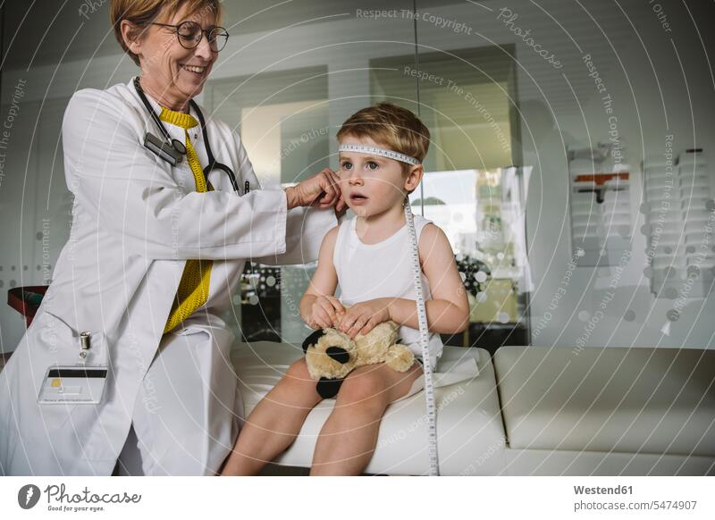 Pediatrician measuring extent of child’s head health healthcare Healthcare And Medicines medical medicine disease diseases ill illnesses sick Sickness patients