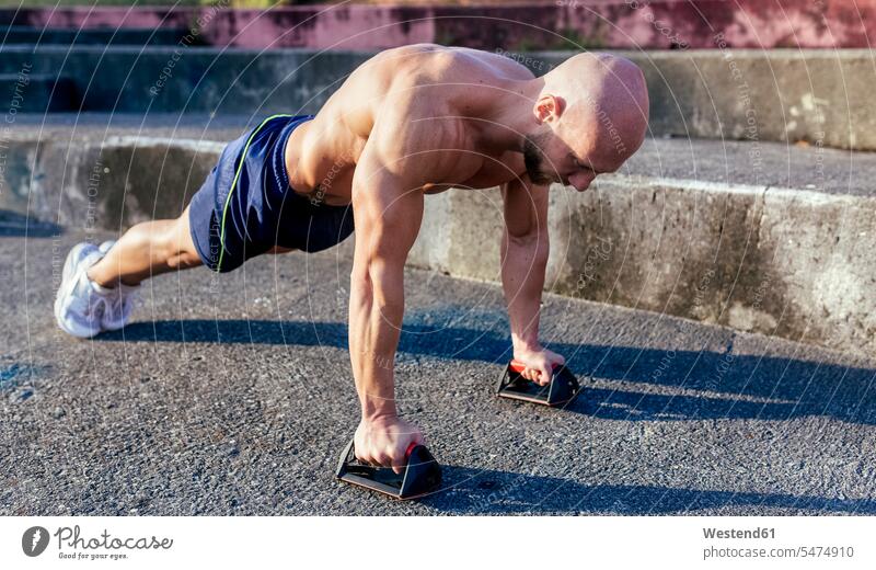 Barechested muscular man doing push-ups outdoors muscles athletic exercising exercise training practising pushup Push-up Push-ups pushups press-up press-ups