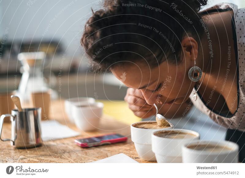 Woman working in a coffee roastery smelling at product Occupation Work job jobs profession professional occupation human human being human beings humans person