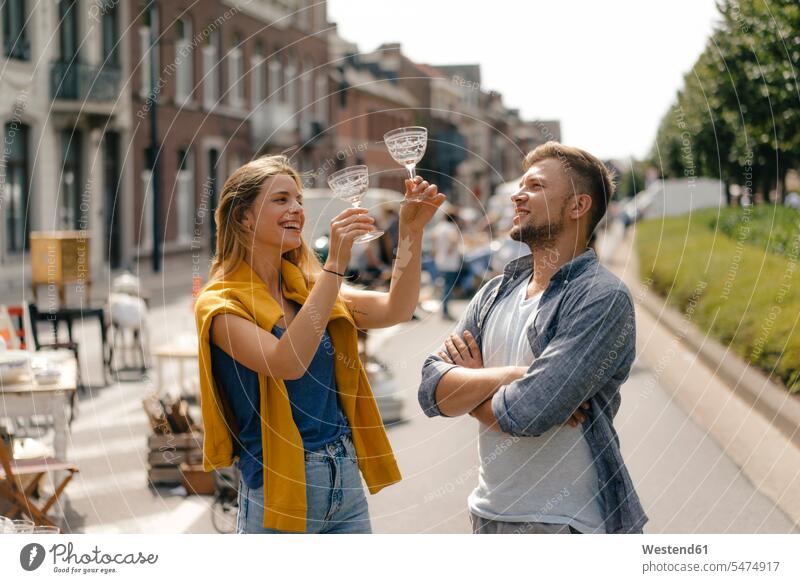 Belgium, Tongeren, happy young couple with glasses on an antique flea market antiques twosomes partnership couples glassware happiness people persons